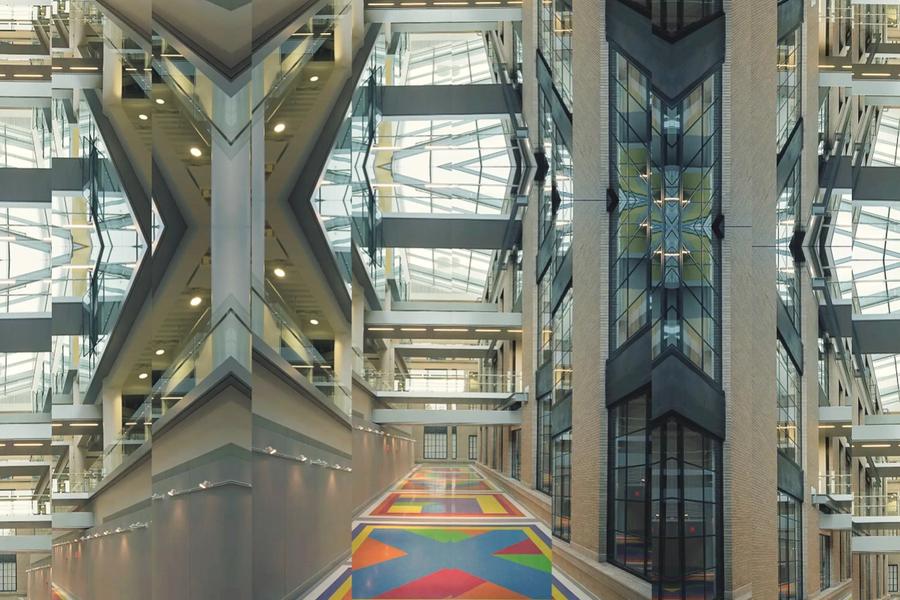 Symmetrical digital collage of MIT’s Building 46 atrium, featuring Sol LeWitt’s Bars of Color within Squares (2007) painted on the floor. The mirrored composition multiplies the geometric ceiling, glass walkways, and colorful floor patterns into a kaleidoscopic architectural view that emphasizes rhythm, repetition, and light.